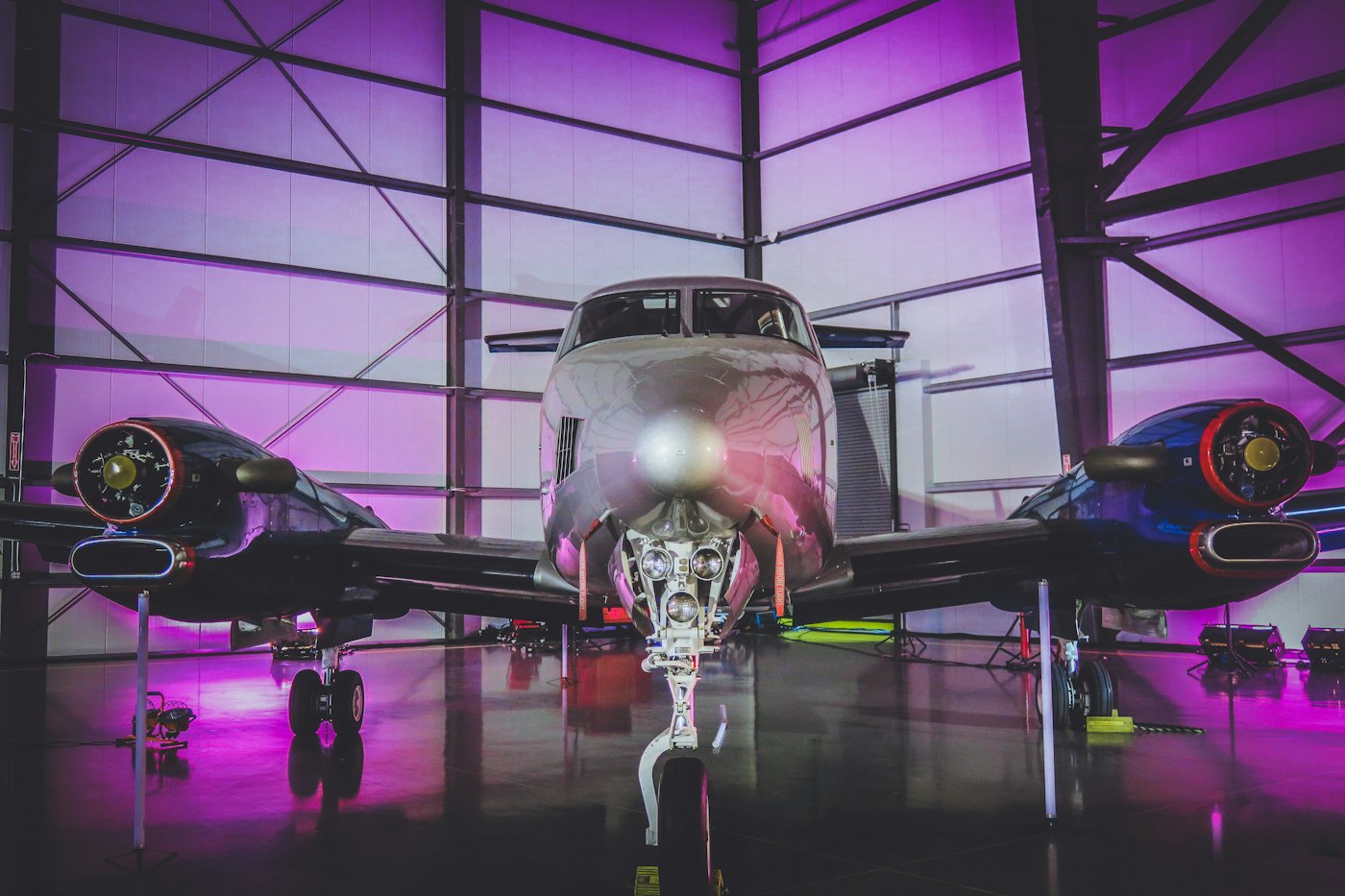 A business turboprop aircraft parked inside a hangar